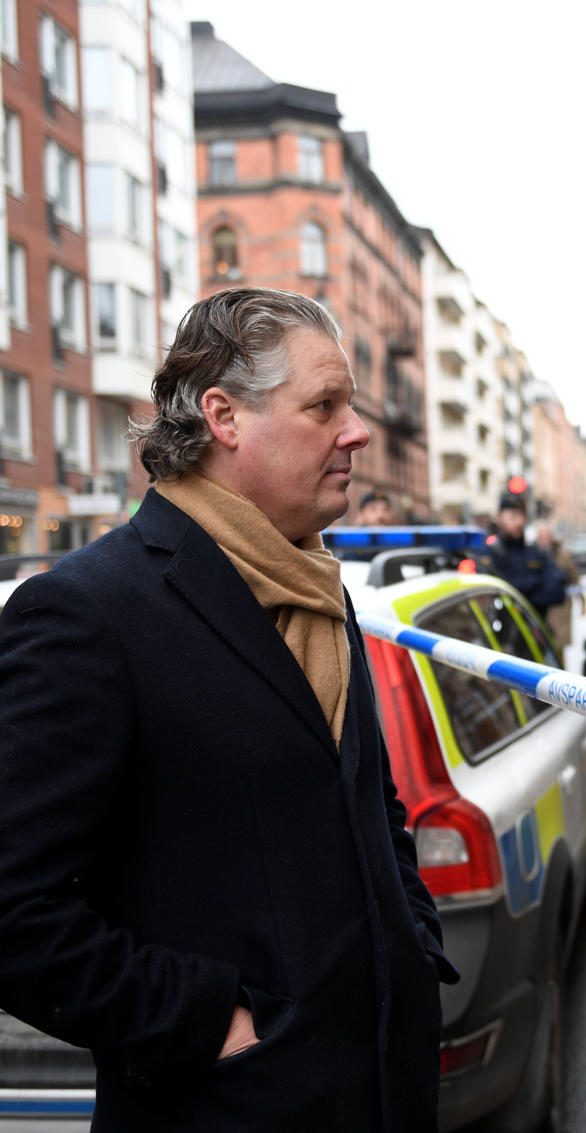 Art gallery owner Peder Enstrom stands behind police cordon after Salvador Dali works have been stolen, in Stockholm