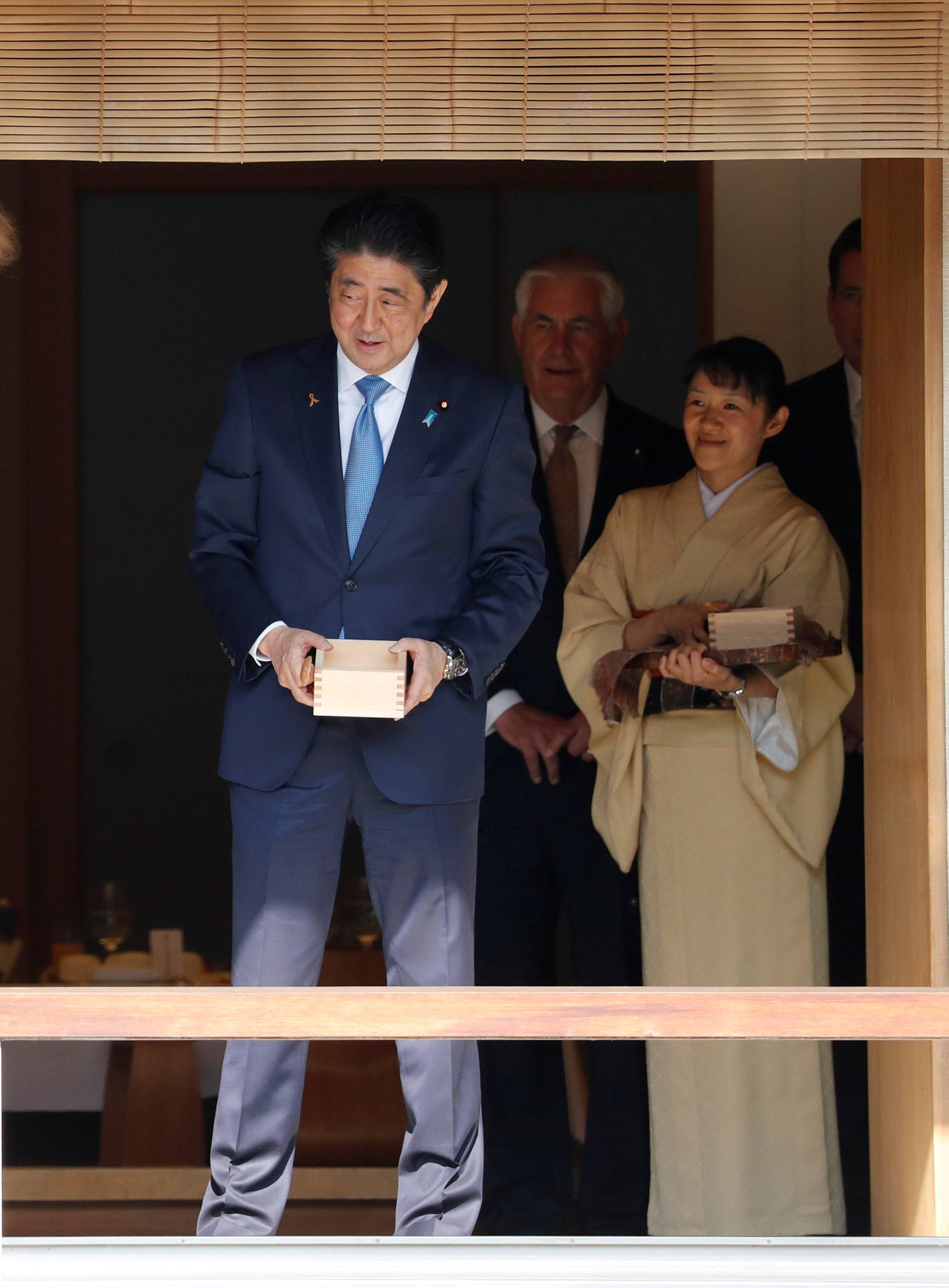 U.S. President Donald Trump and Japan's Prime Minister Shinzo Abe feed carps before their working lunch at Akasaka Palace in Tokyo