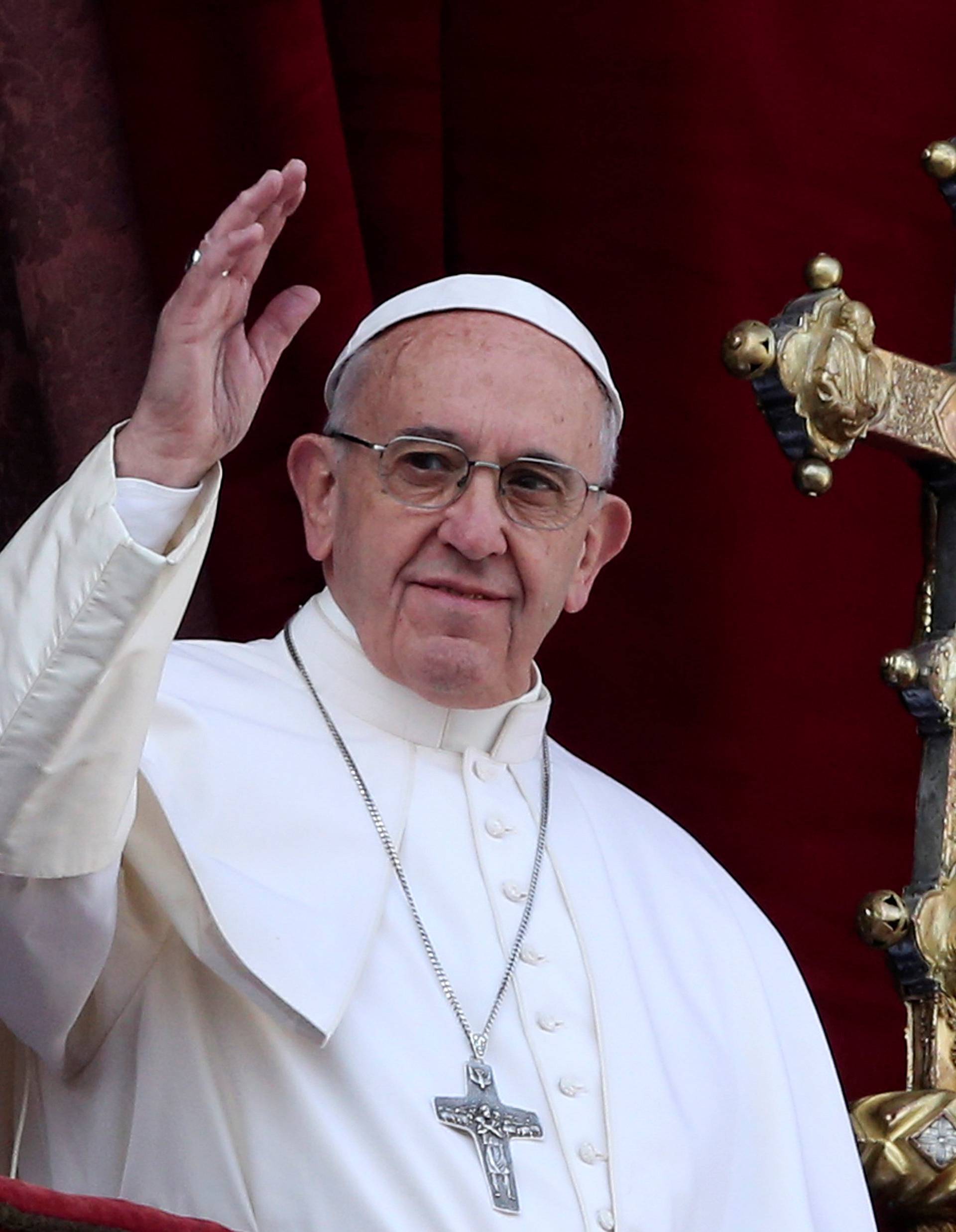 Pope Francis waves after delivering his "Urbi et Orbi" (to the city and the world) message from the balcony overlooking St. Peter's Square at the Vatican