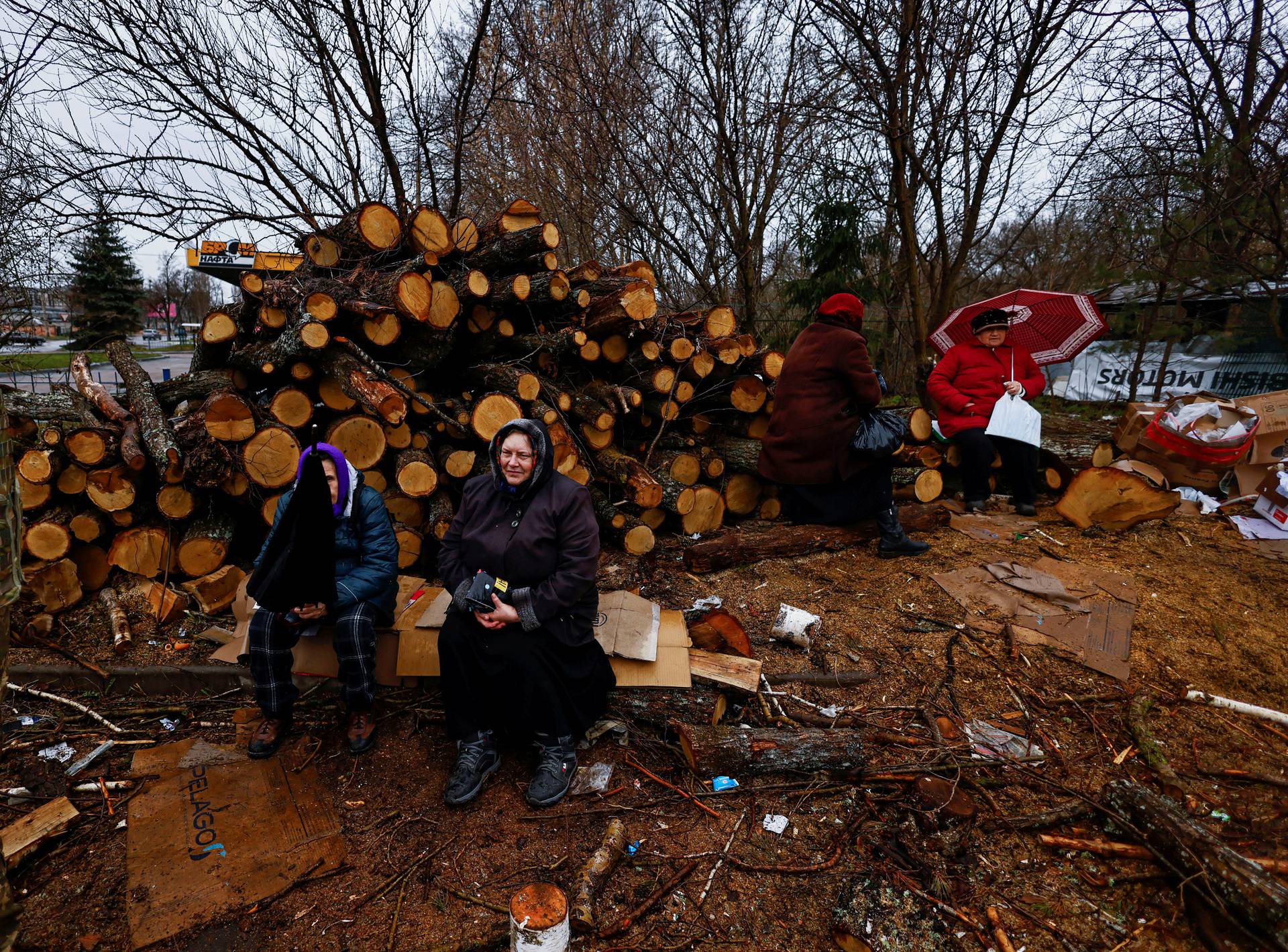 People wait to receive humanitarian aid, amid Russia's Invasion of Ukraine, in Chernihiv