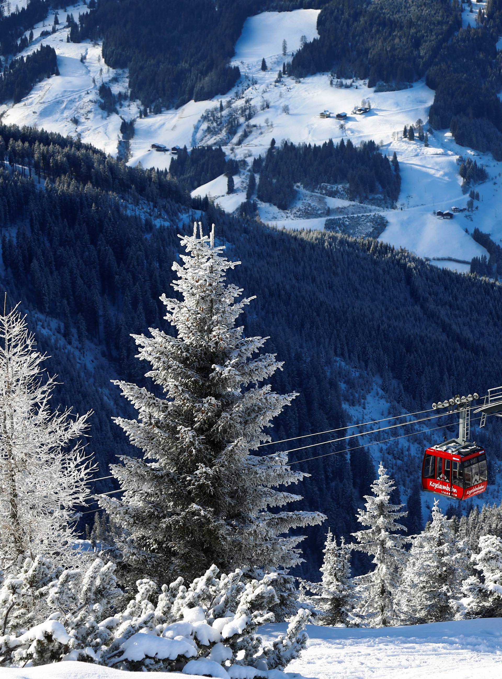 Skiers ride a gondola on a sunny winter's day at the ski resort of Flachau