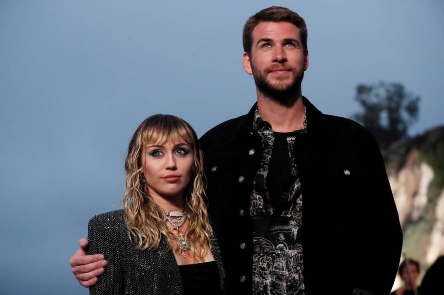 Miley Cyrus and Liam Hemsworth look on at the Saint Laurent Menâs Spring/Summer 2020 fashion show at Paradise Cove beach in Malibu
