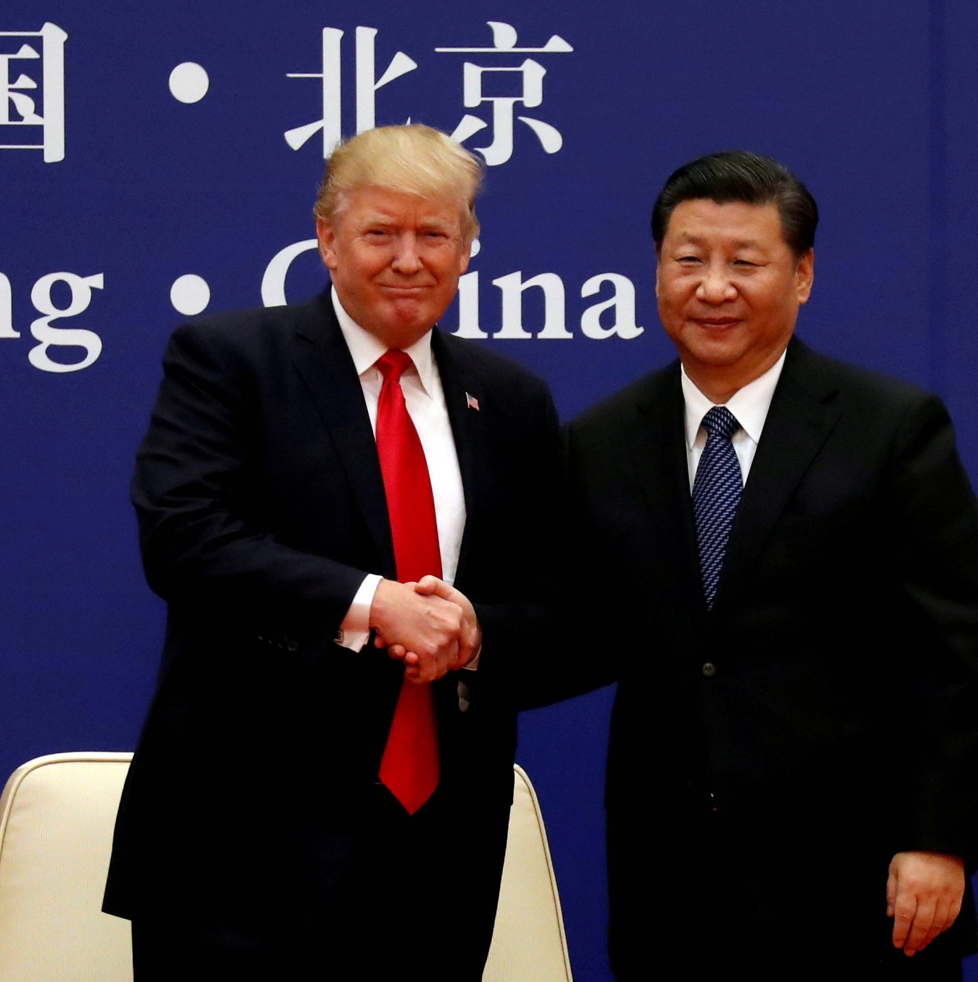 FILE PHOTO: FILE PHOTO: U.S. President Donald Trump and China's President Xi Jinping meet business leaders at the Great Hall of the People in Beijing