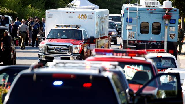 Emergency response vehicles drive near a shooting scene at the Capital Gazette newspaper in Annapolis