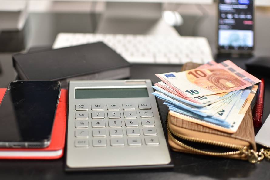 Notepad,,Euro,Bills,,And,Solar-powered,Calculator