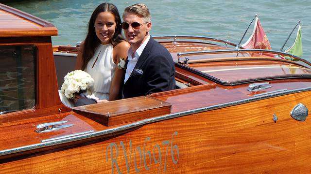 German football player Schweinsteiger and Serbian tennis player Ivanovic sit in a boat after get married in Venice