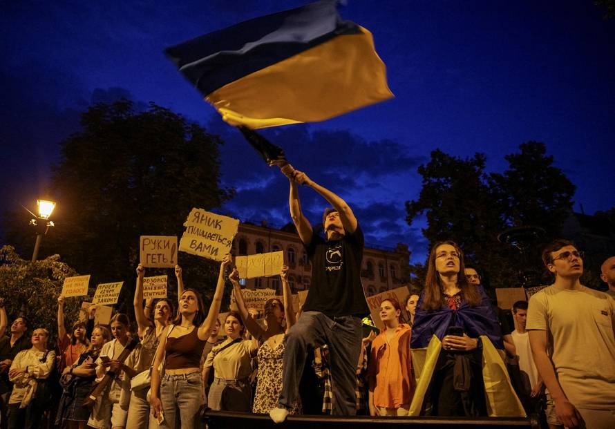 Ukrainians protest against a newly passed law, which curbs independence of anti-corruption institutions near the presidential office in Kyiv