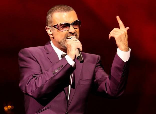 FILE PHOTO British singer George Michael performs on stage during his "Symphonica" tour concert in Vienna