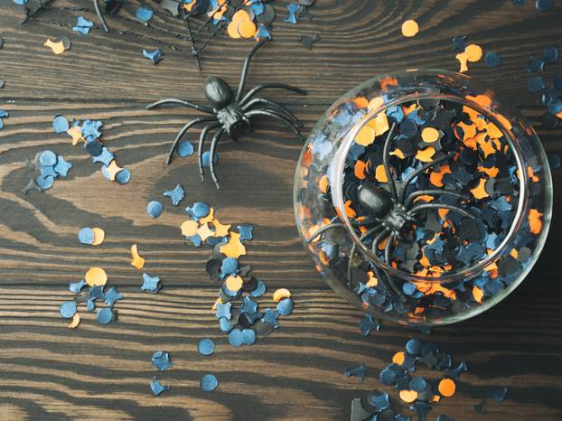 Halloween party confetti on dark background