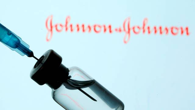 FILE PHOTO: Vial and sryinge are seen in front of displayed Johnson&Johnson logo in this illustration taken
