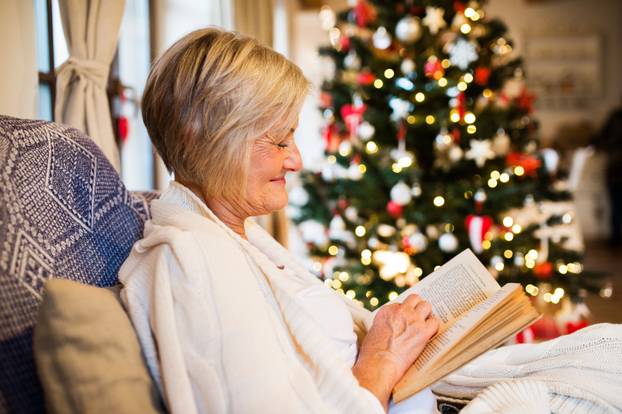 Senior woman in front of Christmas tree