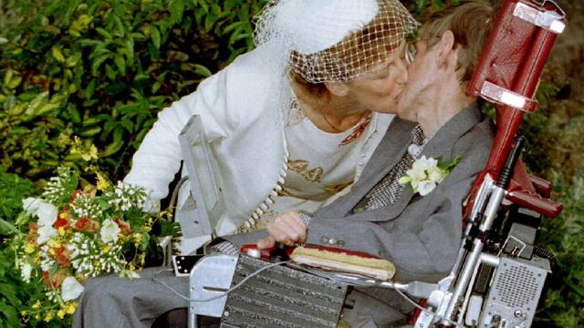 A kiss for scientist and theorist Stephen Hawking from his new bride Elaine Mason after their civil ..