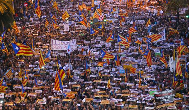 Protesters hold banners during a demonstration called by pro-independence associations asking for the release of jailed Catalan activists and leaders, in Barcelona