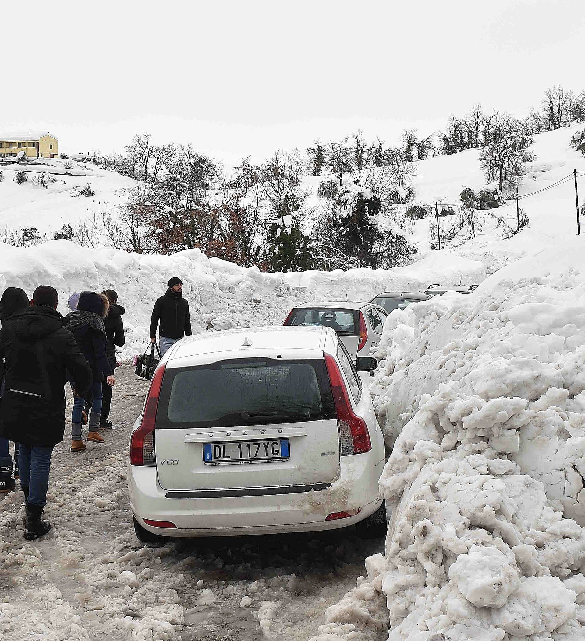 People walk in the town of Penne, central Italy, following a series of earthquakes and a snow avalanche hitting a hotel in central Italy