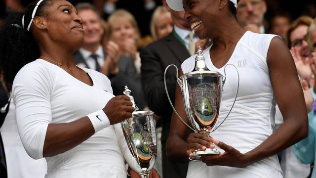 FILE PHOTO: Venus Williams celebrate winning 2016 Wimbledon women's doubles title with her sister Serena Williams
