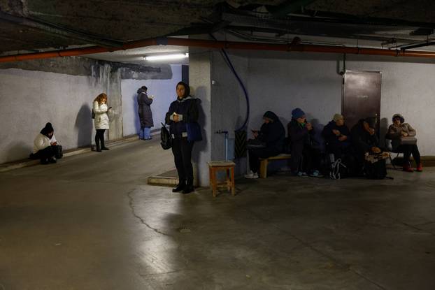 People take shelter inside an underground parking lot during a Russian missile and drone attack in Kyiv