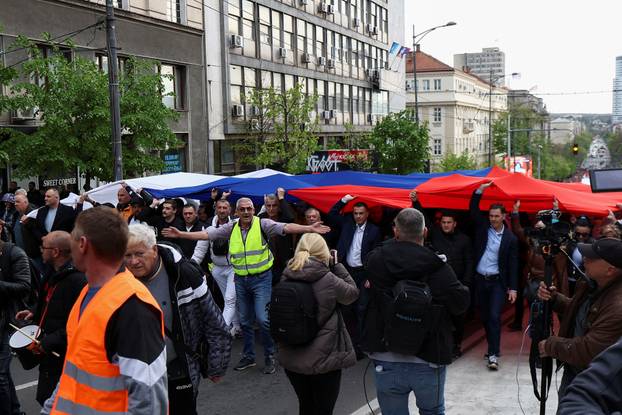 People attend a rally in support of policies of the President Aleksandar Vucic