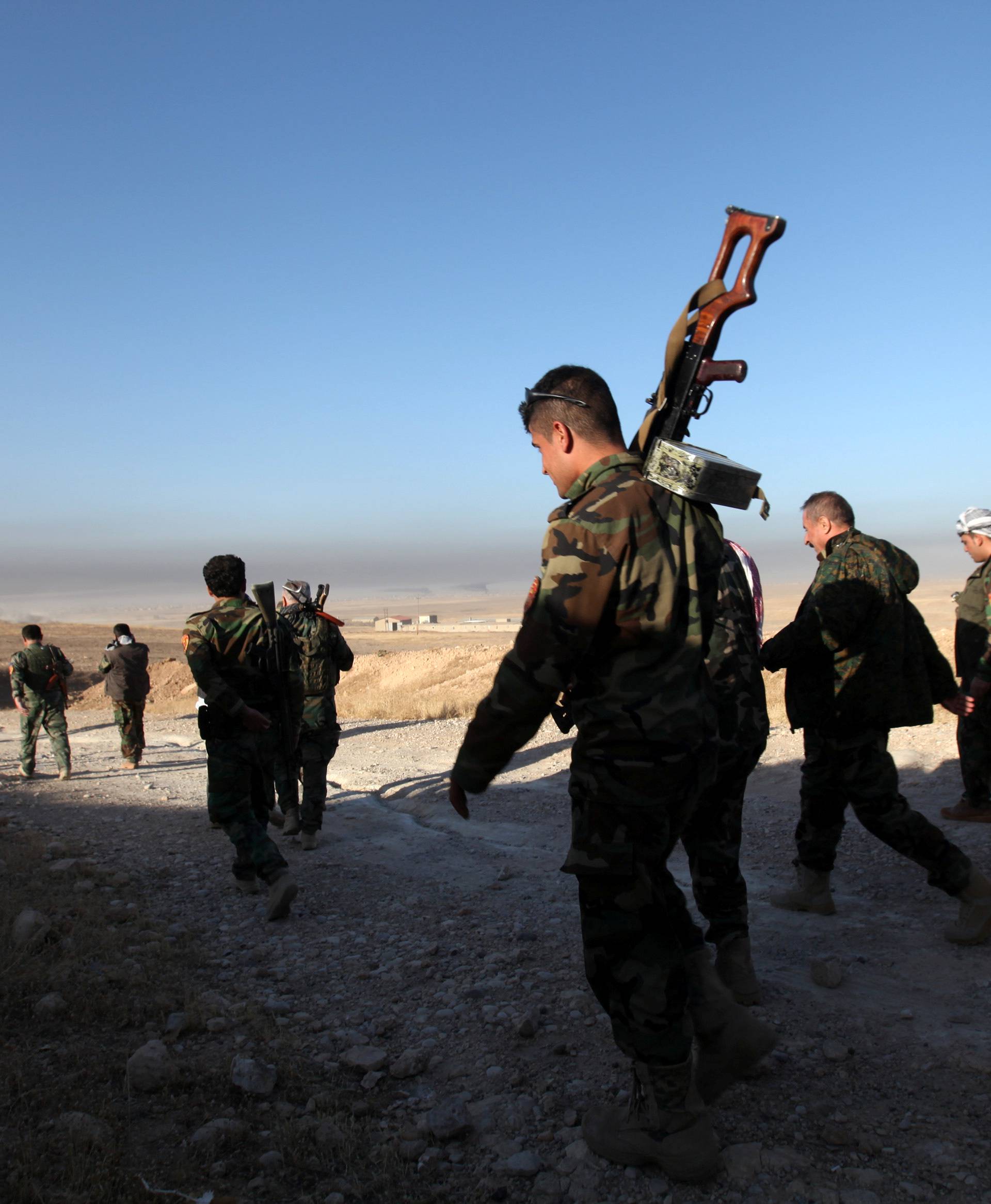 Peshmerga forces walk in the east of Mosul during operation to attack Islamic State militants in Mosul