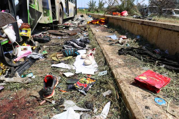 Scattered shoes lie on the ground near damaged buses after an explosion yesterday at insurgent-held al-Rashideen