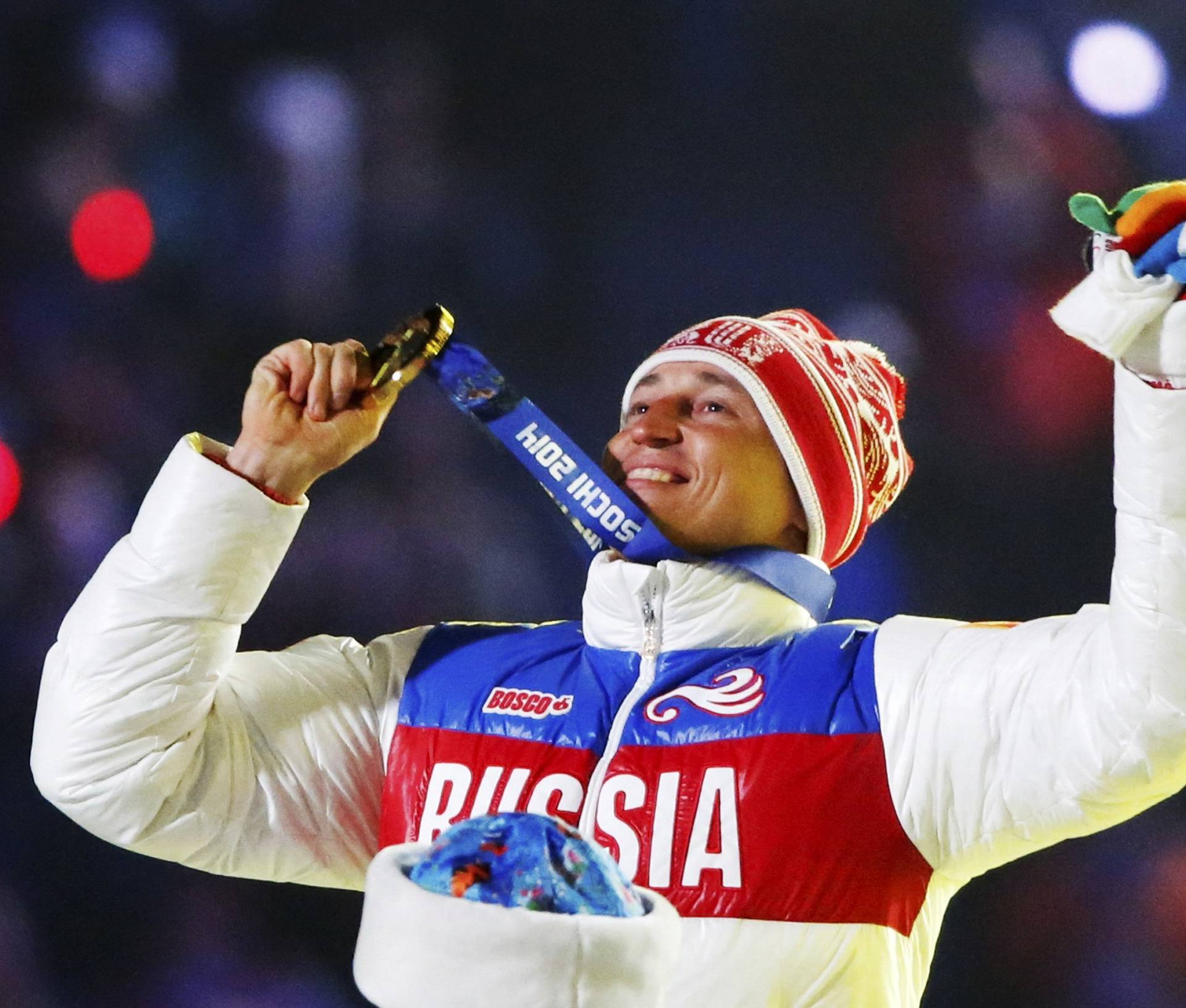 FILE PHOTO: Russian gold medalist Legkov celebrates as he receives his medal during closing ceremony for Sochi 2014 Winter Olympics