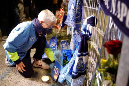 People gather to mourn the death of Argentine soccer legend Diego Maradona outside San Paolo stadium in Naples