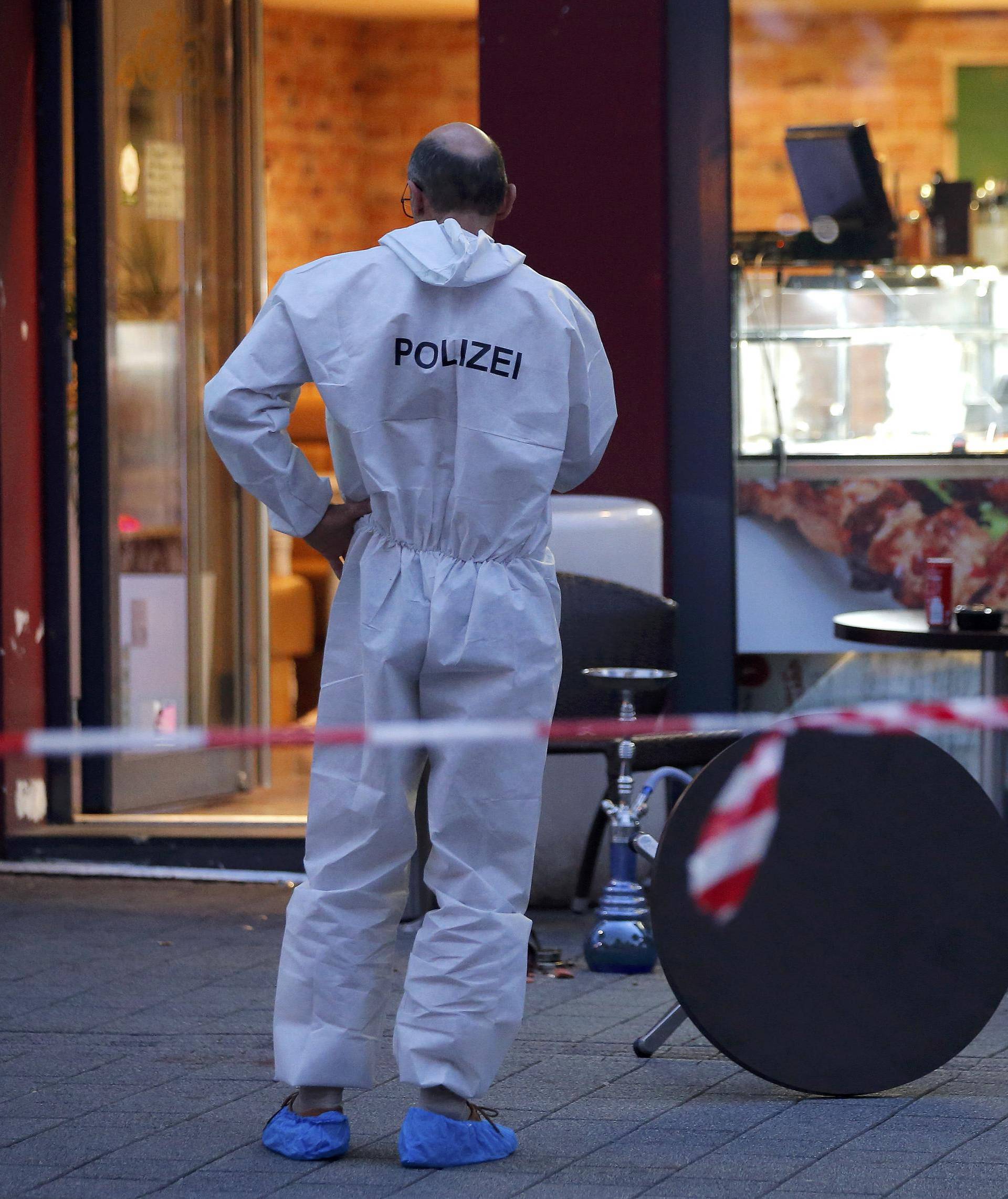 A police forensic expert works outside where a 21-year-old Syrian refugee killed a woman with a machete in Reutlingen