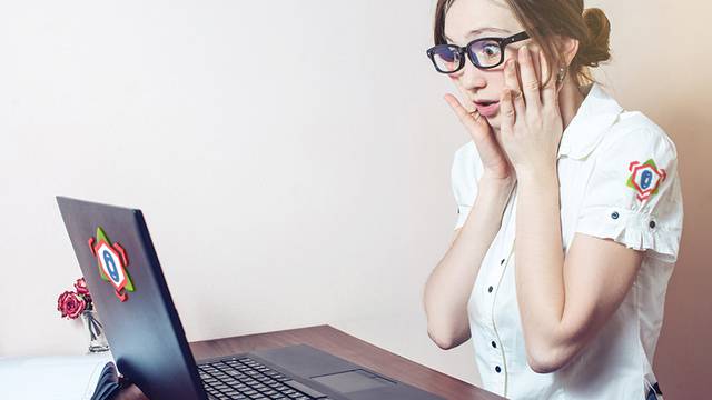 attractive woman working at office with laptop grabs his head