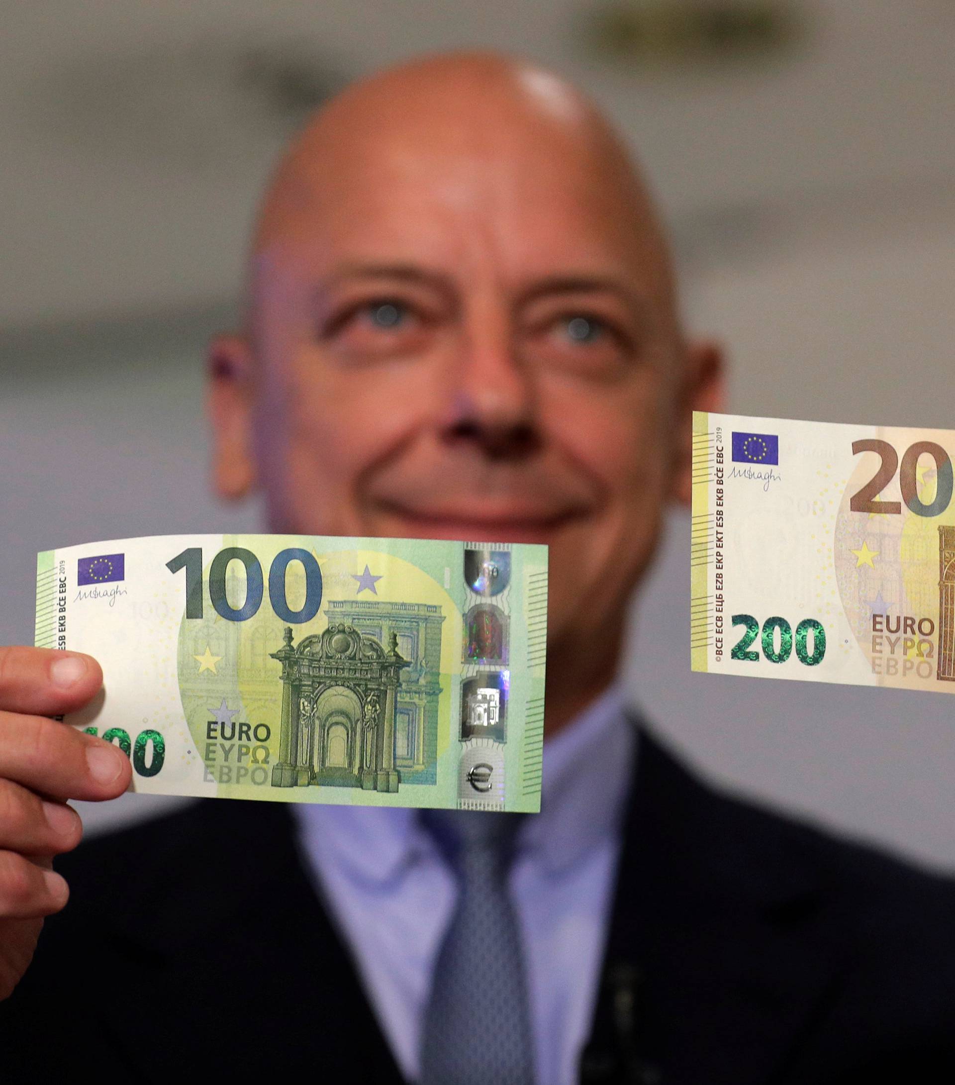 Austrian Central Bank Director Kurt Pribil displays new 100 and 200 euro banknotes in Vienna