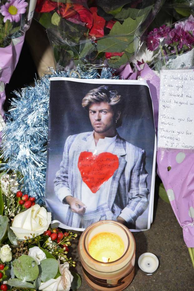 Fans continue to lay flowers and tributes outside the Oxfordshire home of George Michael