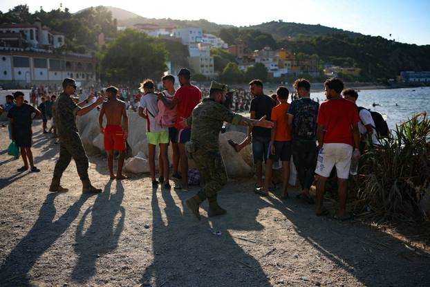 Mass crossings of migrants on foot and by sea from Morocco into Spanish territory, in Ceuta