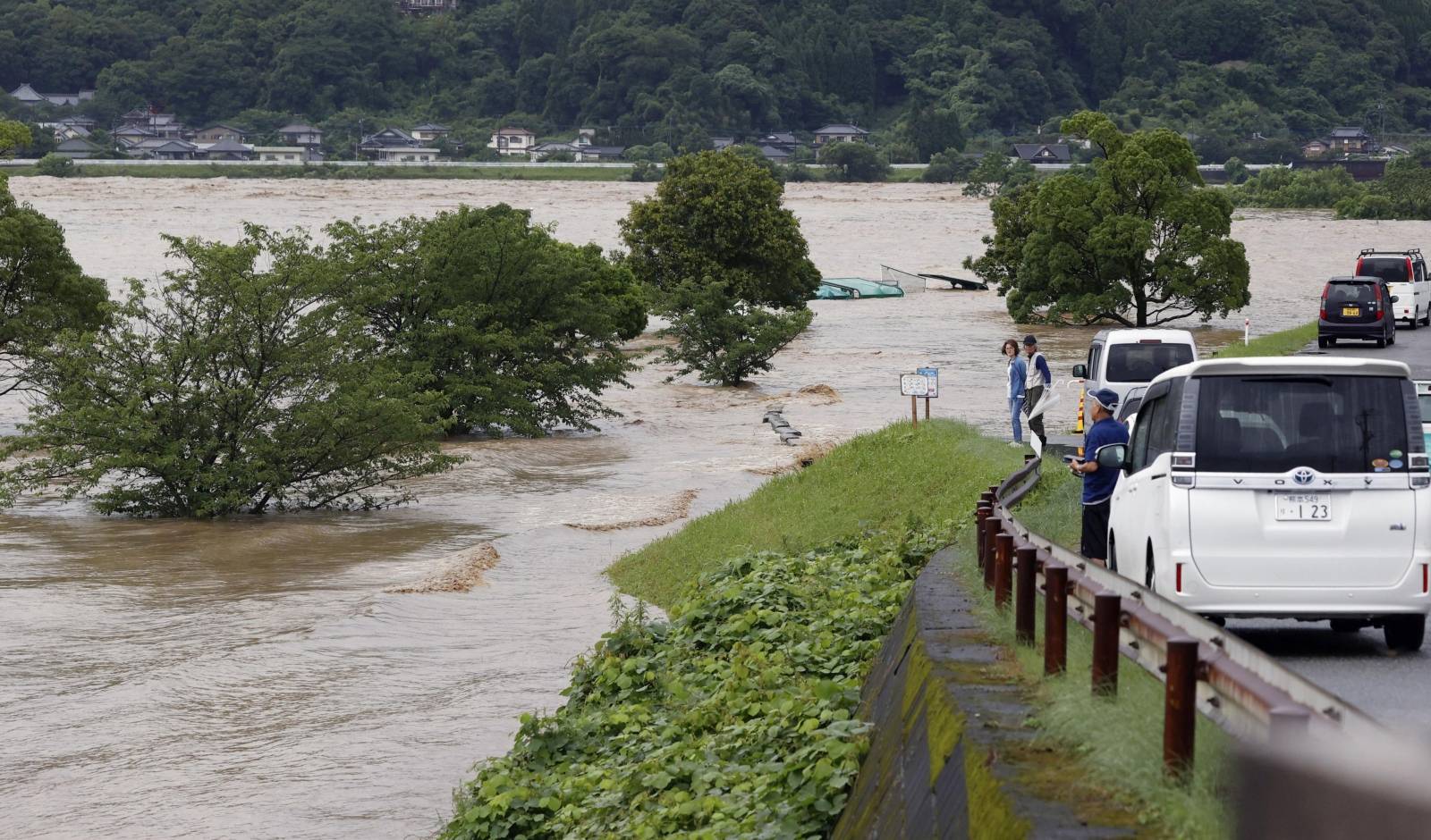 Rising water caused by a heavy rain is seen along Kuma river in Yatsushiro, Japan