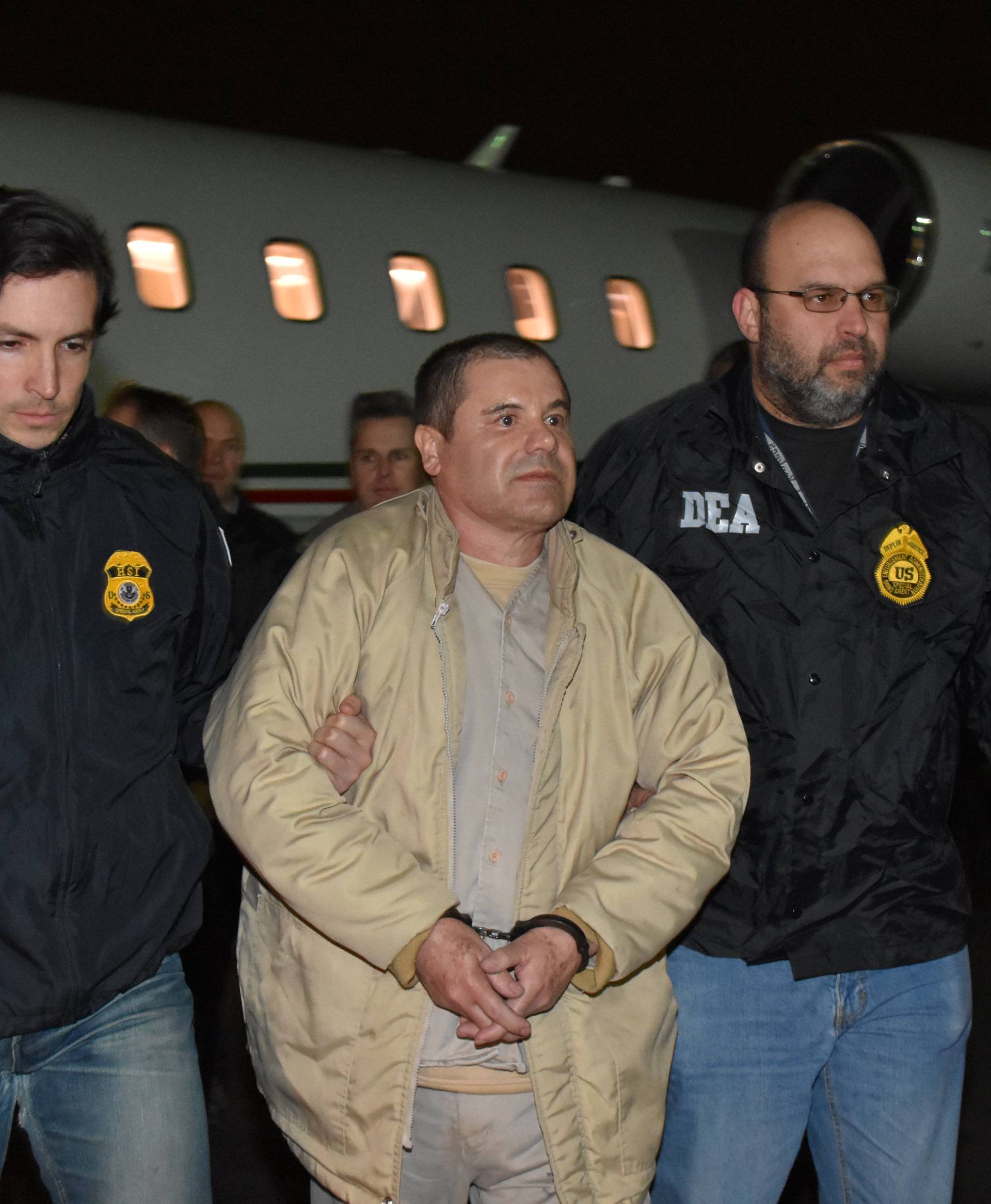 Mexico's top drug lord Joaquin "El Chapo" Guzman is escorted as he arrives at Long Island MacArthur airport in New York