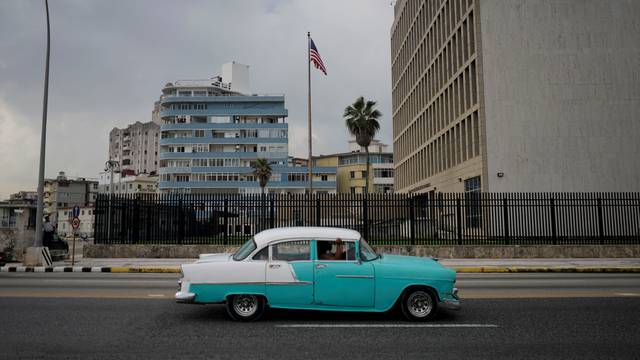FILE PHOTO: A vintage car passes by the U.S. Embassy in Havana
