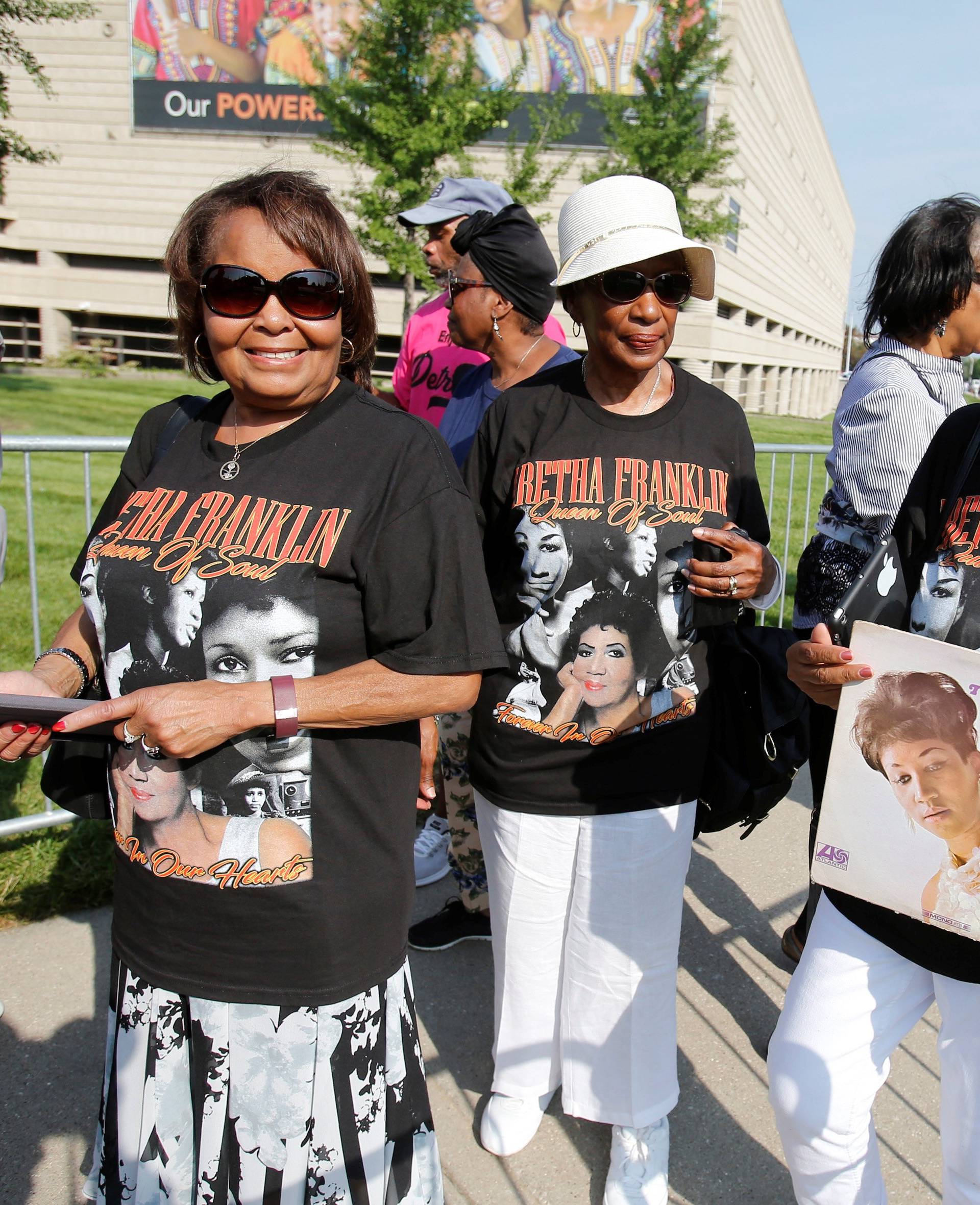 June Burnette holds an album by singer Aretha Franklin as she waits in line for Franklin's viewing at the Charles H. Wright African American Museum in Detroit