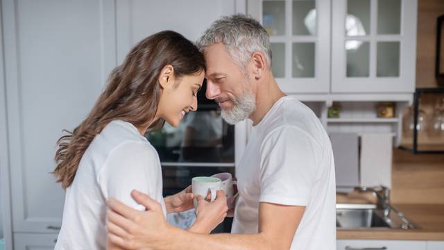 Man and woman hugging each other while having coffee