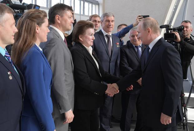 Russian President Vladimir Putin greets Valentina Tereshkova, the first woman cosmonaut, during a visit to the historical Space Pavilion opened after a renovation in Moscow