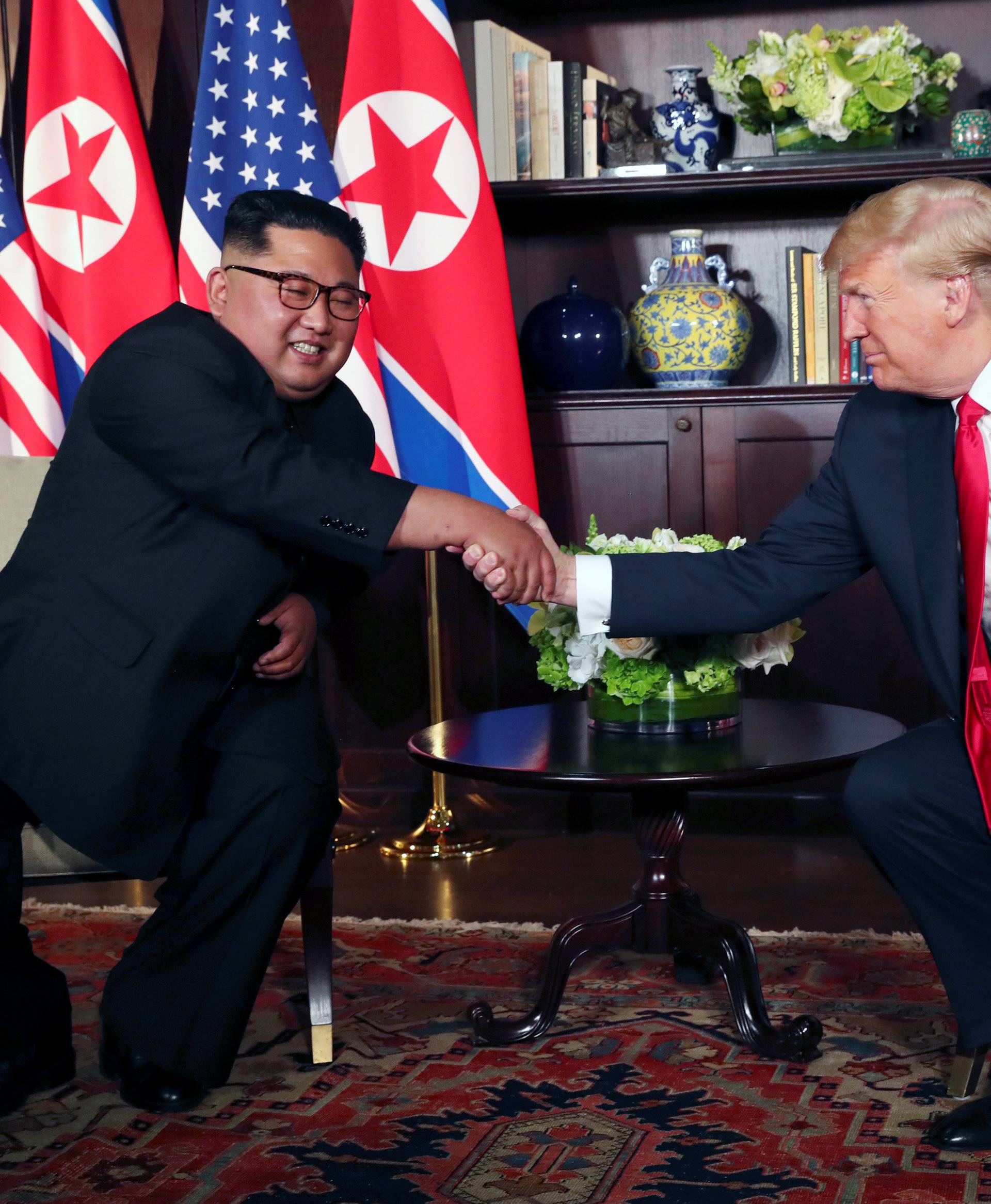 U.S. President Donald Trump shakes hands with North Korea's leader Kim Jong Un at the Capella Hotel in Singapore