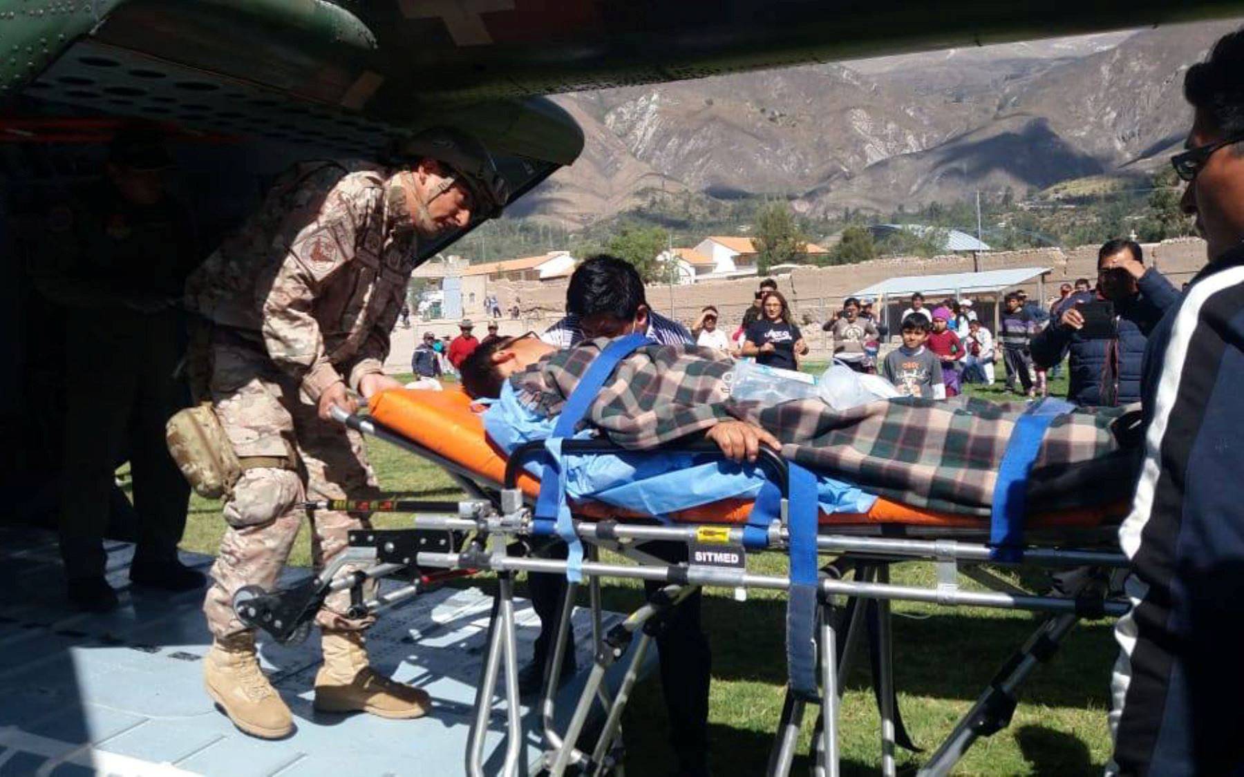 A person is transported to a helicopter after eating contaminated food at a funeral in the Peruvian Andes, in Ayacucho