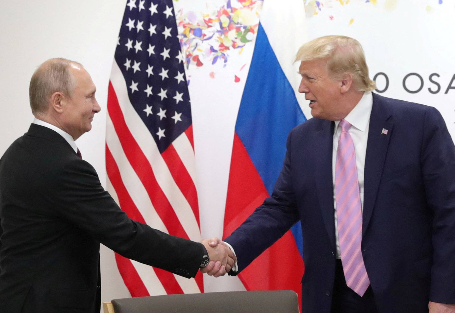 FILE PHOTO: Russia's President Vladimir Putin and U.S. President Donald Trump attend a meeting on the sidelines of the G20 summit in Osaka