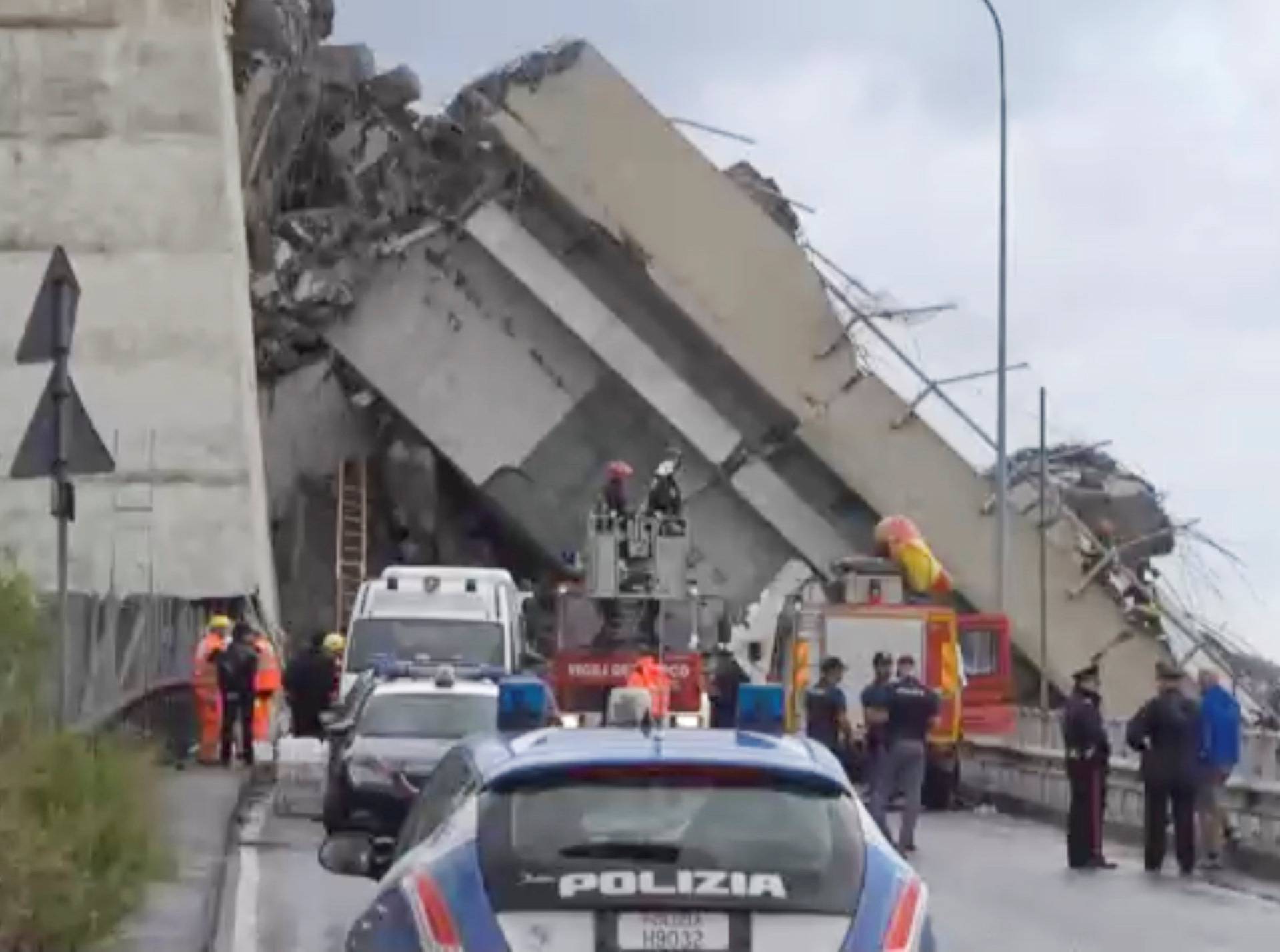 Rescue workers are seen at the collapsed Morandi Bridge in the Italian port city of Genoa