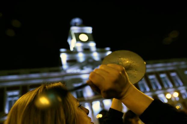 Women bang pots and pans during a protest at the start of a nationwide feminist strike on International Women