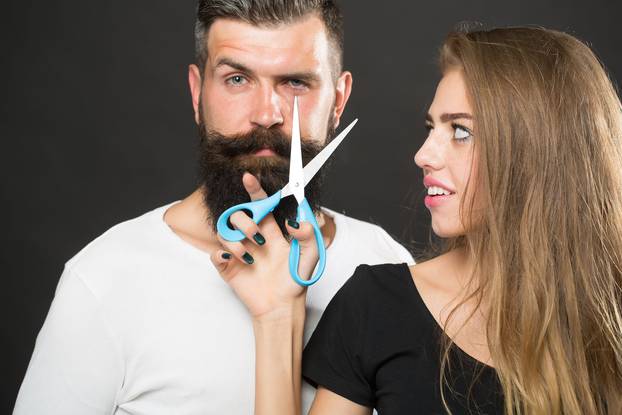 Fashionable couple with scissors