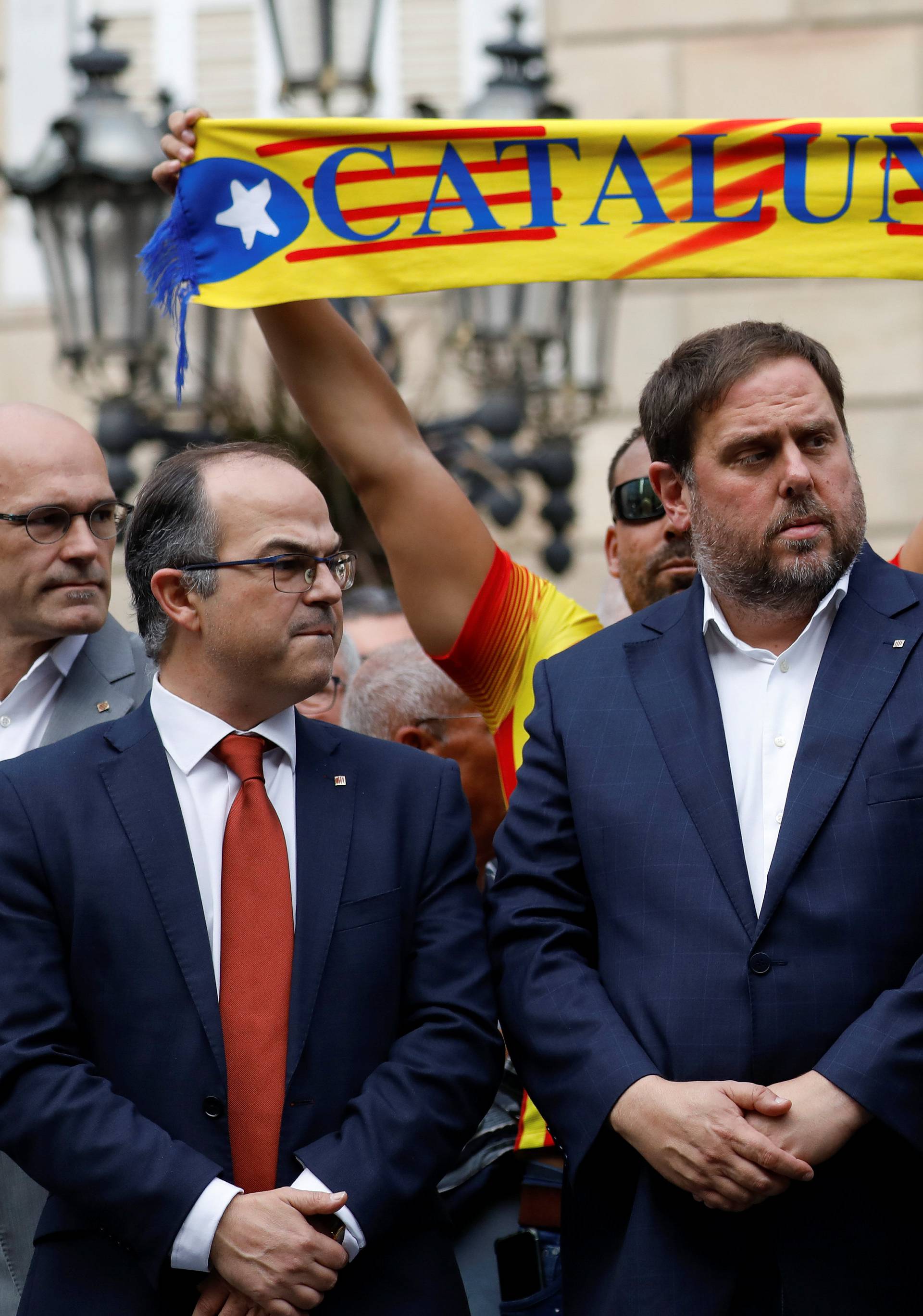 Catalan President Carles Puigdemont and other dignitaries stand in Plaza Sant Jaume in Barcelona