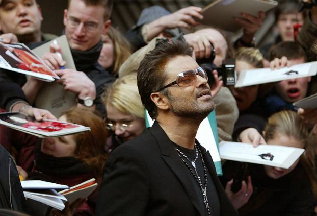 FILE PHOTO British singer and actor George Michael leaves a news conference