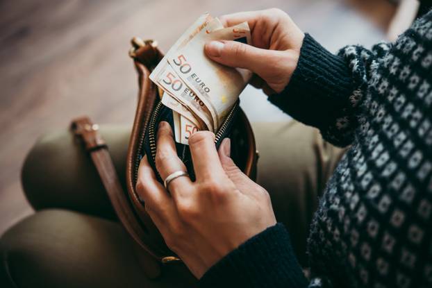 Girl's,Hands,Holding,Euro,Bills,,Small,Money,Pouch,And,Leather