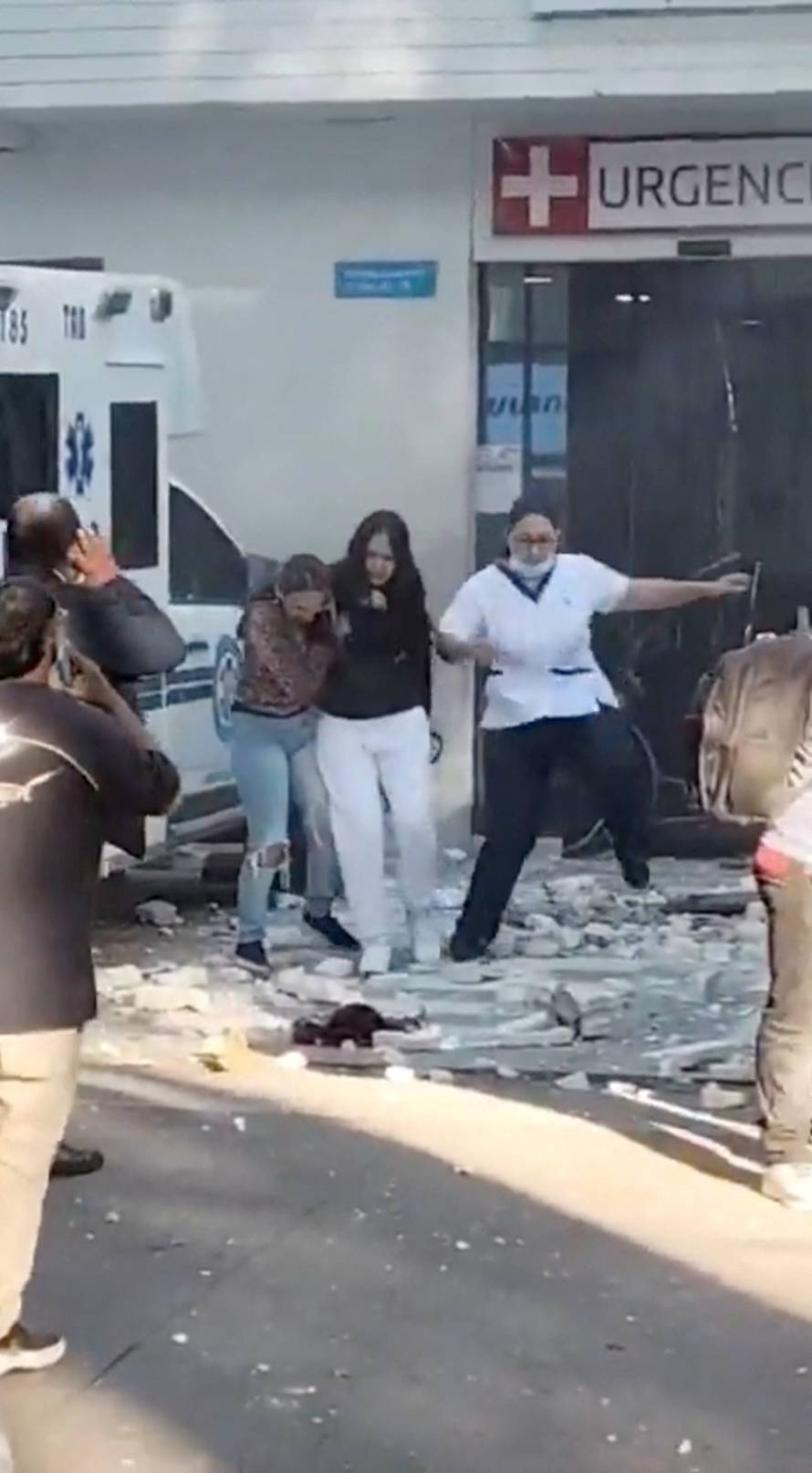 People run out of the hospital building during an earthquake in Cali