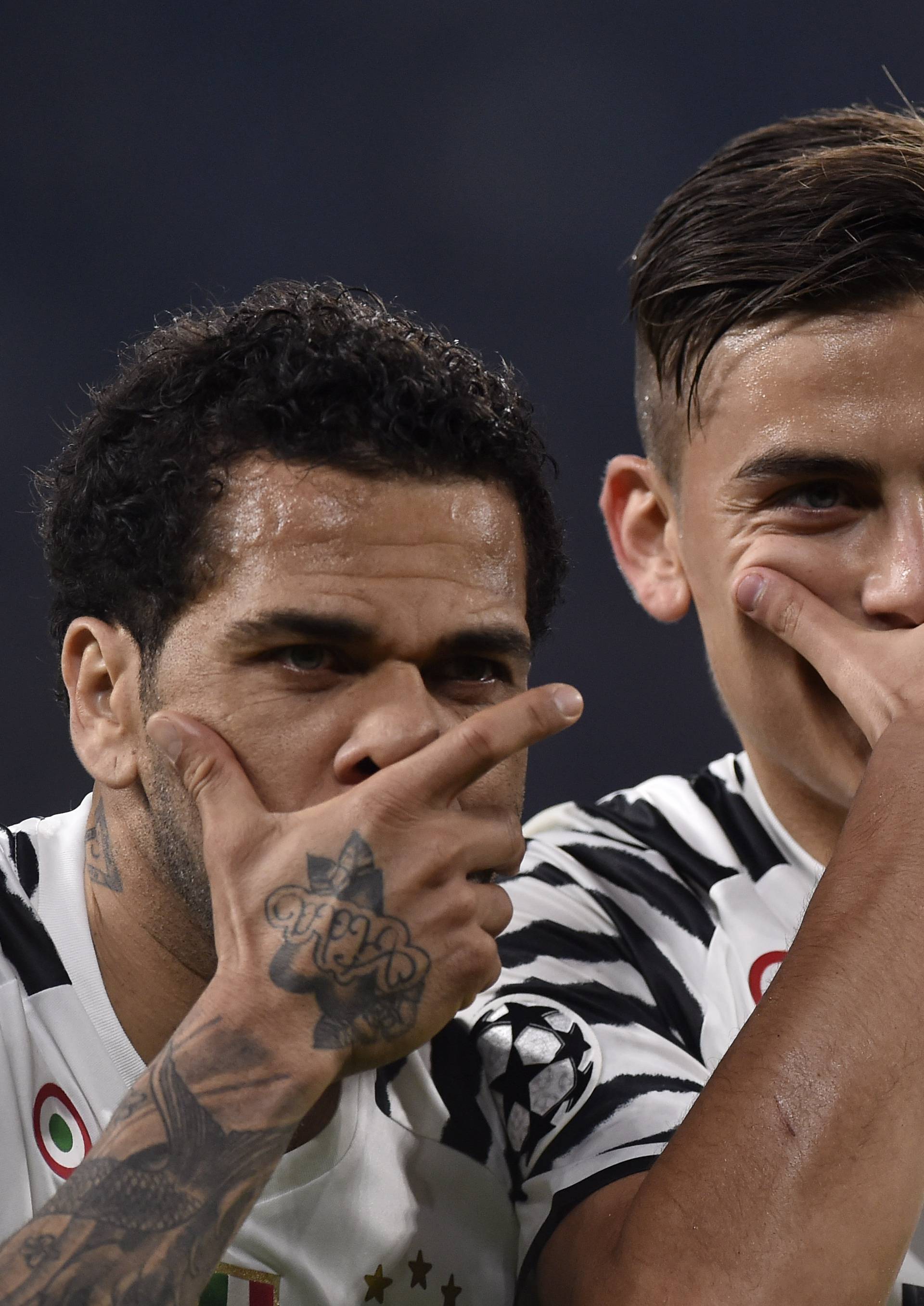 Juventus' Paulo Dybala celebrates scoring their first goal with Dani Alves