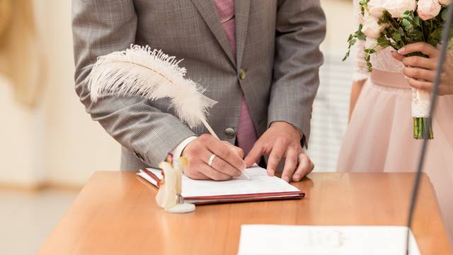 Bride and bridegroom signing the marriage contract after the wedding ceremony
