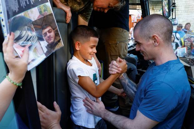 Freed Ukrainian POWs return after a swap in an undisclosed location in Ukraine