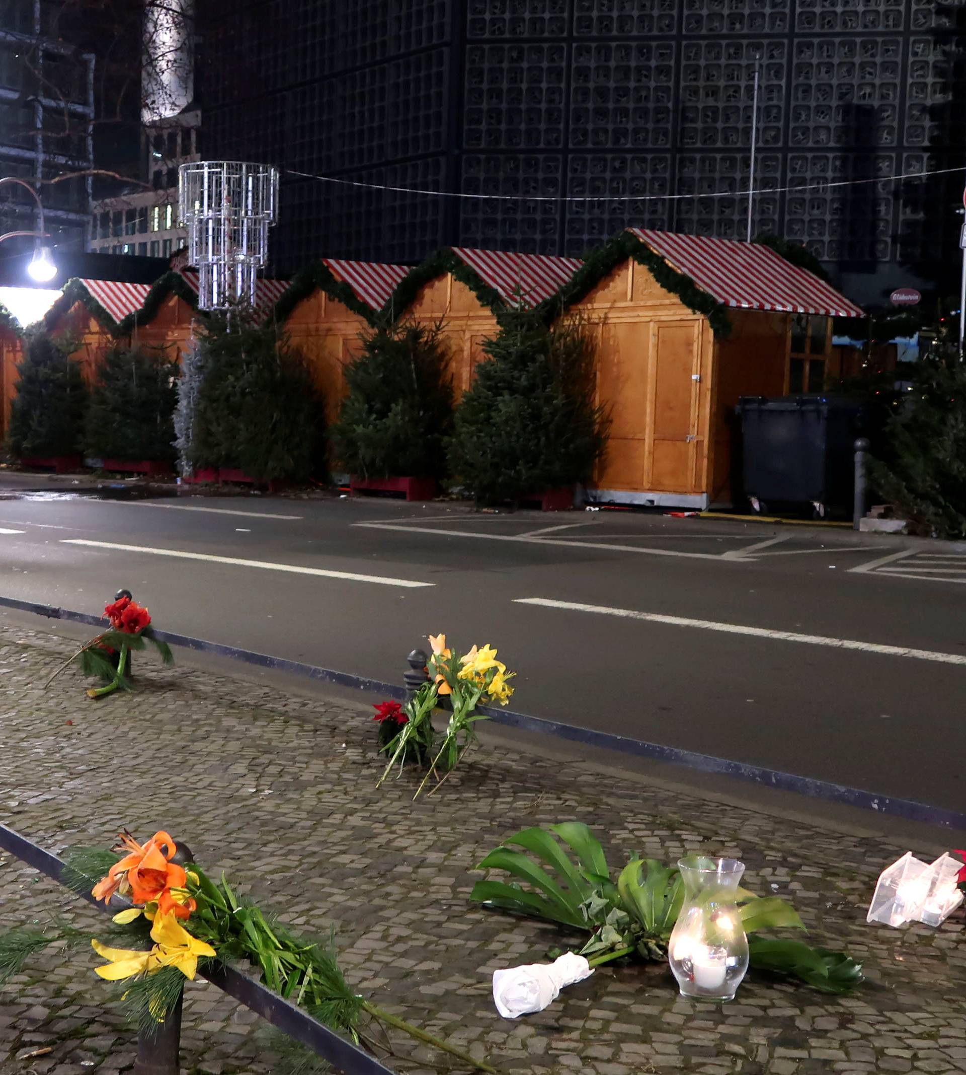 Candles and flowers are seen near the site where a truck ploughed through a crowd at a Berlin Christmas market